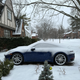 a blue 2023 porsche 911 carrera on a snow-covered road in michigan